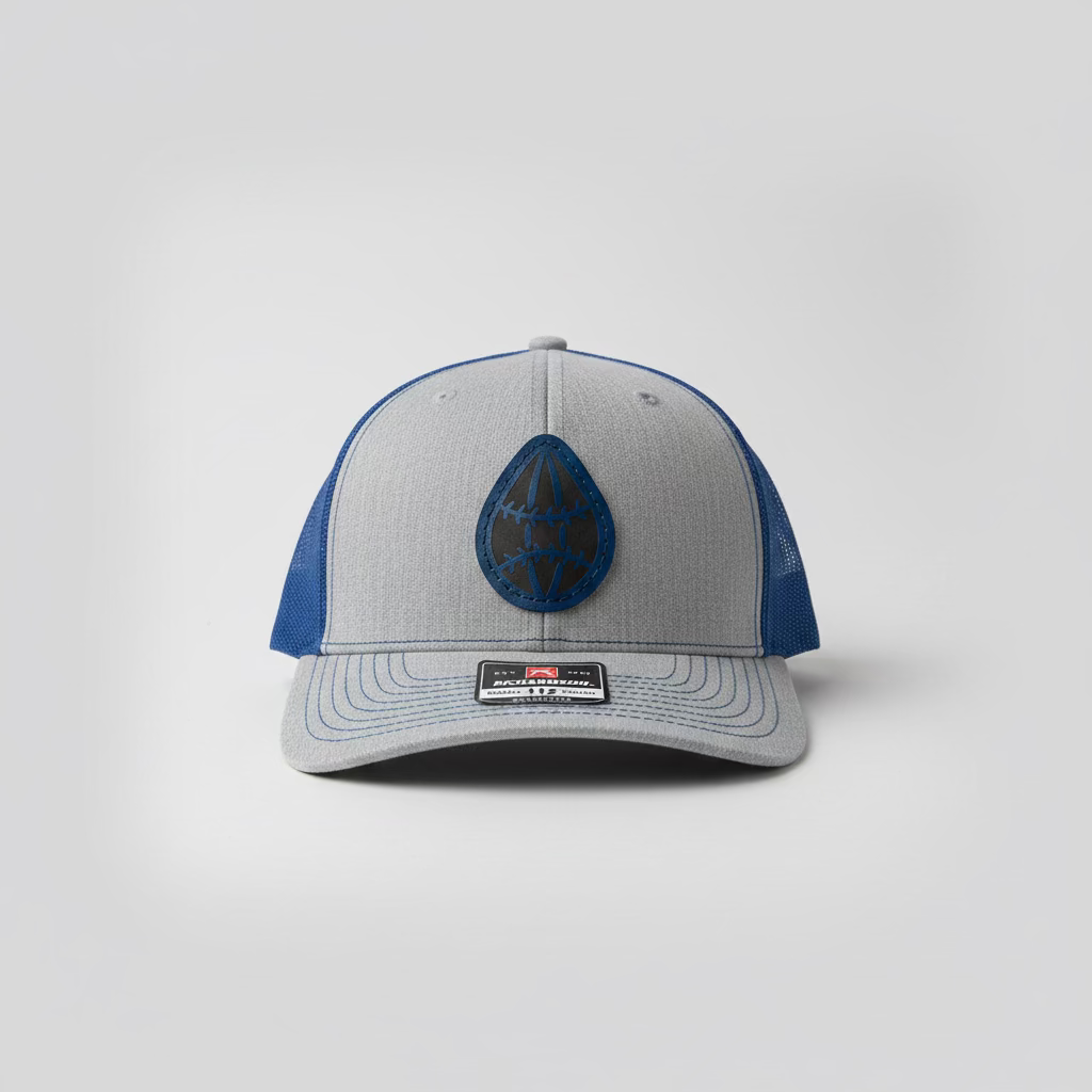 Gray and blue cap with a logo on a light gray background